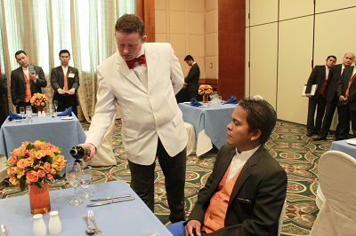 Wayne Fitzharris, a master butler and trainer, teaches the art of pouring serving wine. Photo courtesy of Pan Pacific Manila